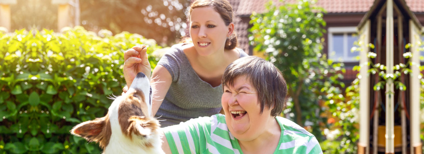 women playing with dog